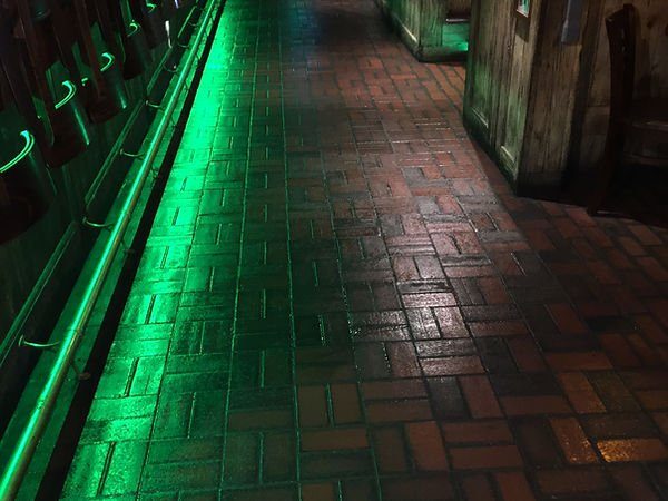 Brick floor behind a bar after scrubbing