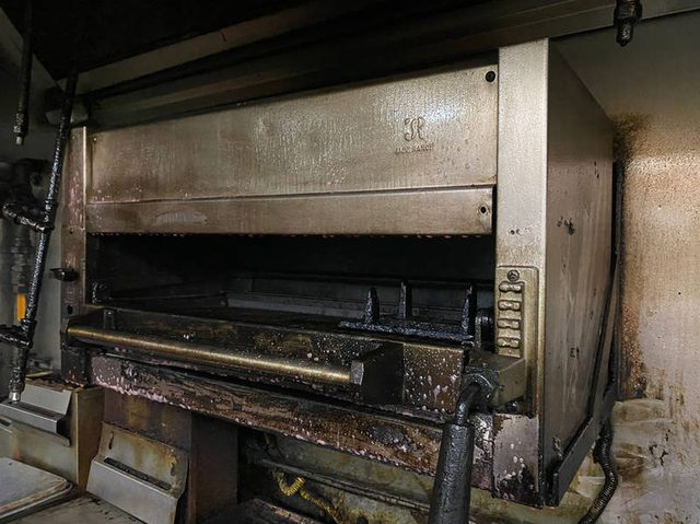 Broiler cabinet with built-up carbon before cleaning