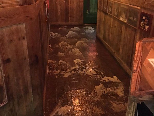 Restaurant dining room brick floor being scrubbed between booths