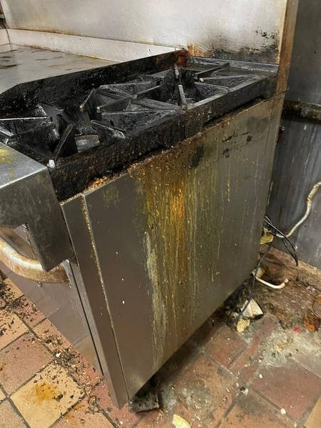 Range with grease running down the stainless steel front before cleaning